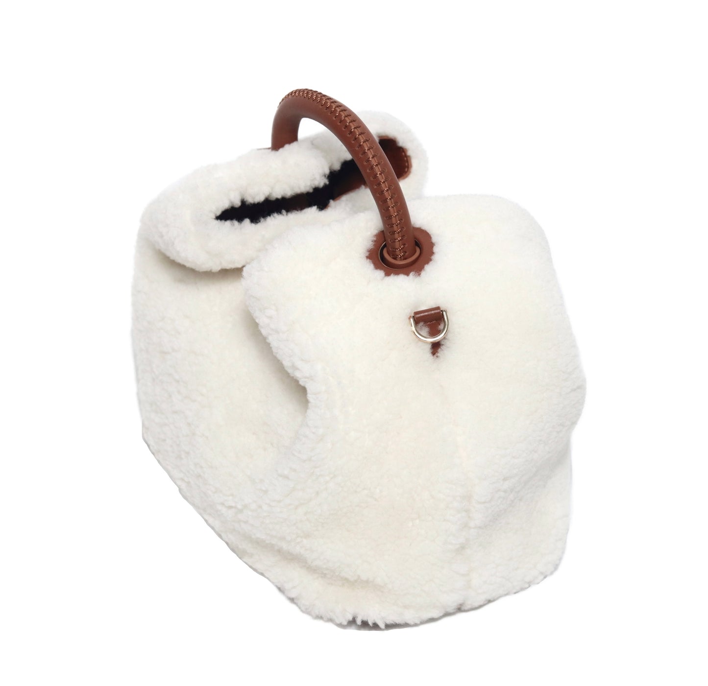 The Celia bag. Made from smooth white shearling wool and brown cowhide leather. Top handle bag. Designed to last 