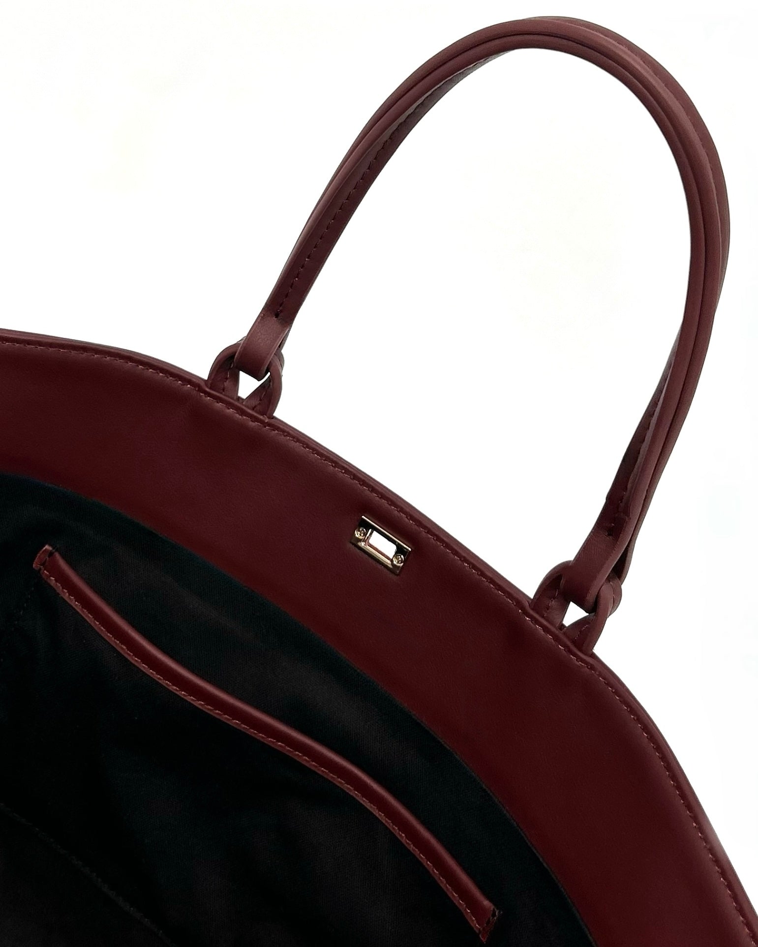 The Colette Tote bag. Made from a gorgeous dark red cowhide leather. Top handle bag with a twist lock closure. Features 3 interior zip pockets. Designed to last 